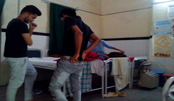 tourist's towel and garments spread on on bed of male ward of mount abu hospital