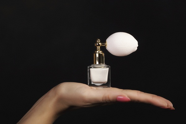 female hand with perfume bottle