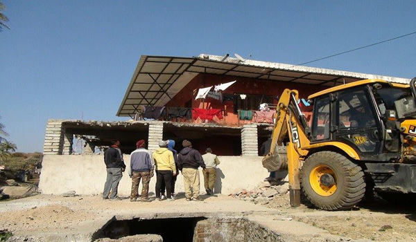 jcb demolishing illegal construction in archana dave's house in mount abu