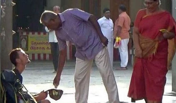 russian tourist sat at the entrance of sri kumarakottam temple in kancheepuram after his atm