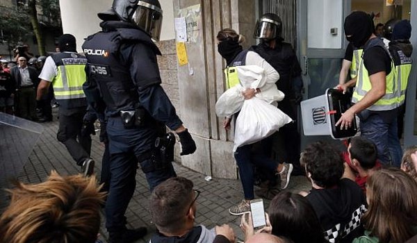 Dozens injured as police scuffle with voters in banned Catalonia poll