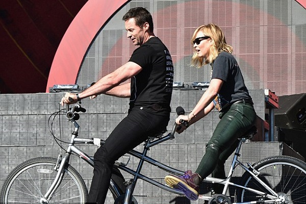 Hue Jackman with child-bearing afroon while riding bike