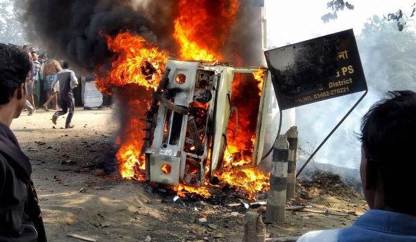 Irate mob set affire a police jeep after a public bus