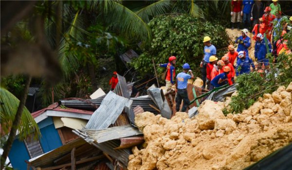 Landslide kills 12 in the Philippines, dozens feared trapped